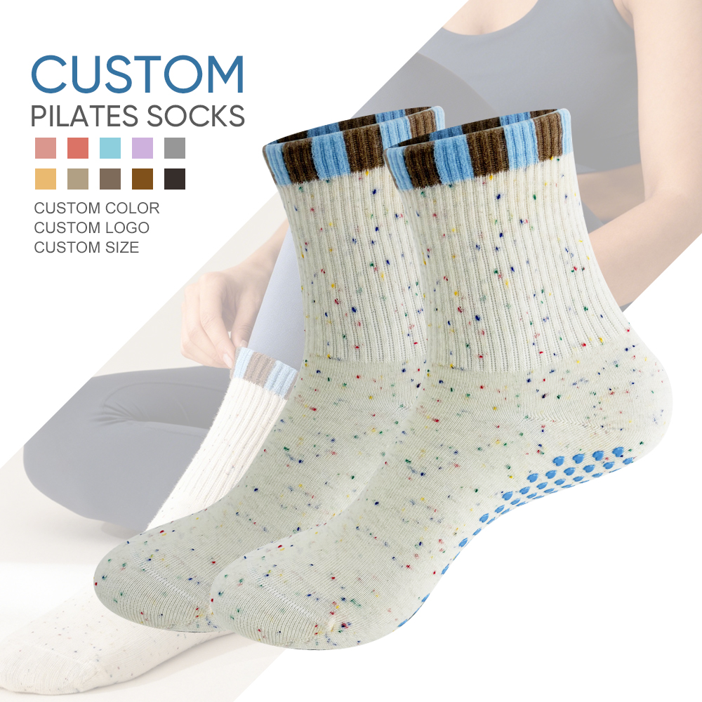 Cream speckled crew Pilates grip socks with blue and brown color-block cuffs and blue sole grips